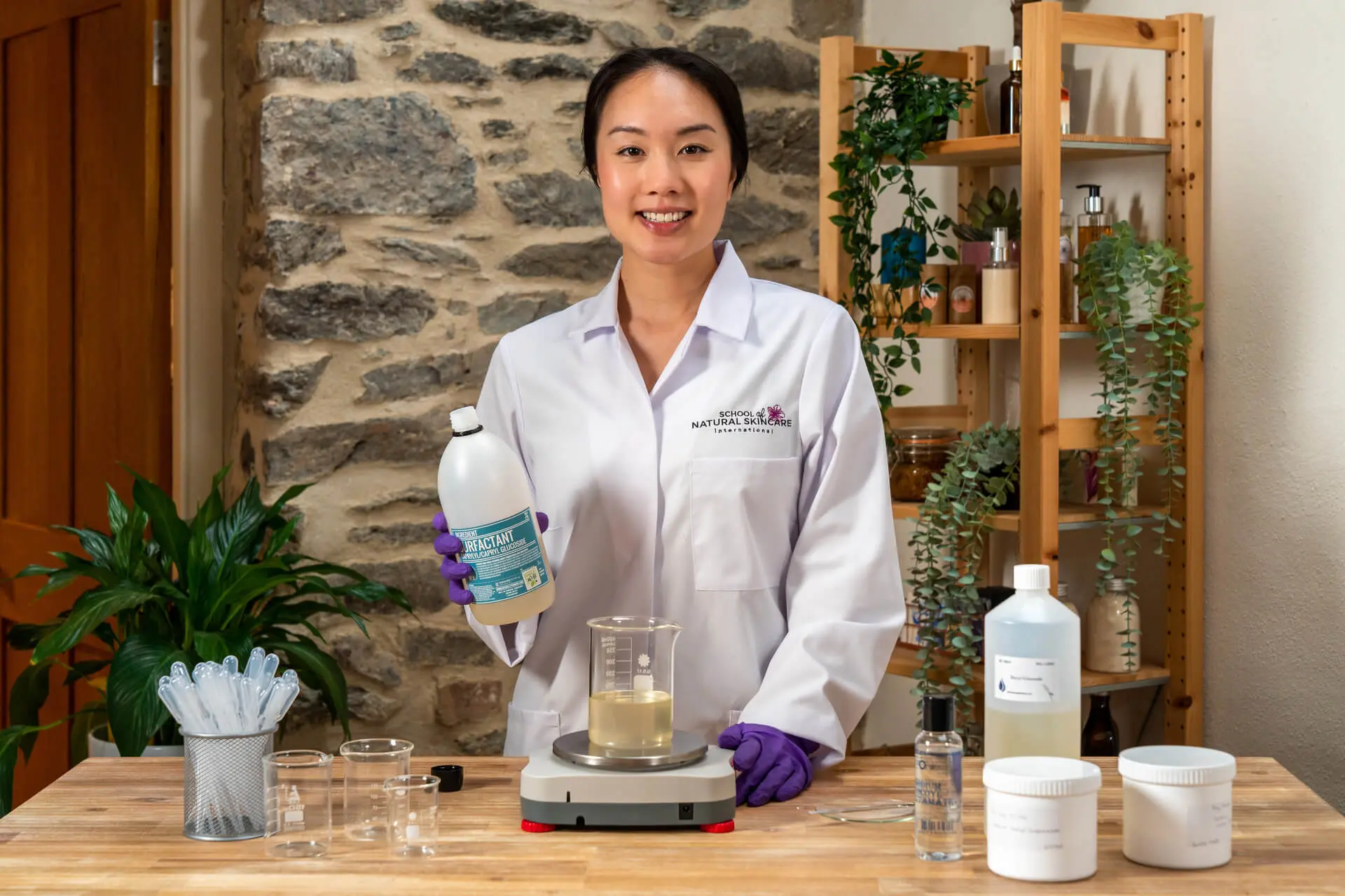 Person in lab coat with skincare ingredients.