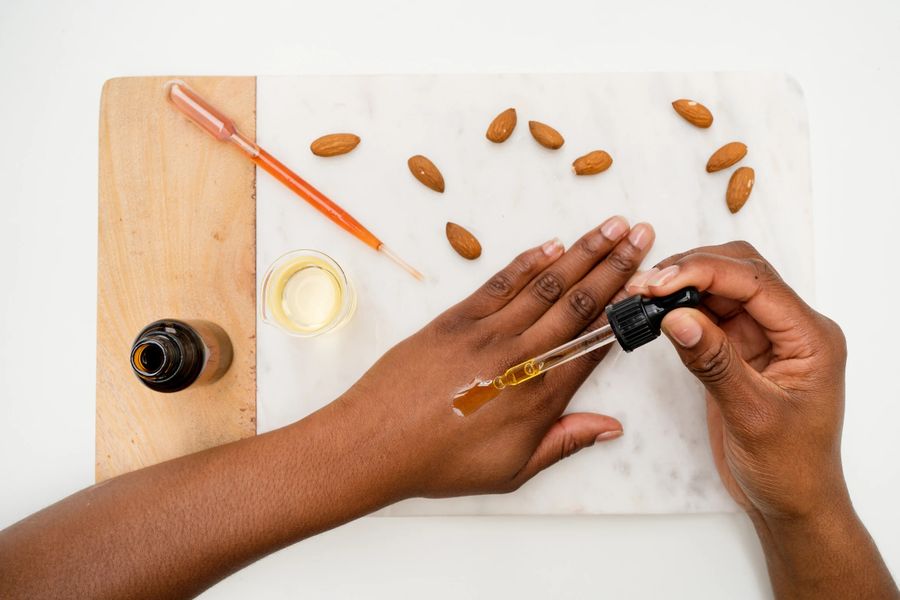 Applying almond oil to hands for skincare