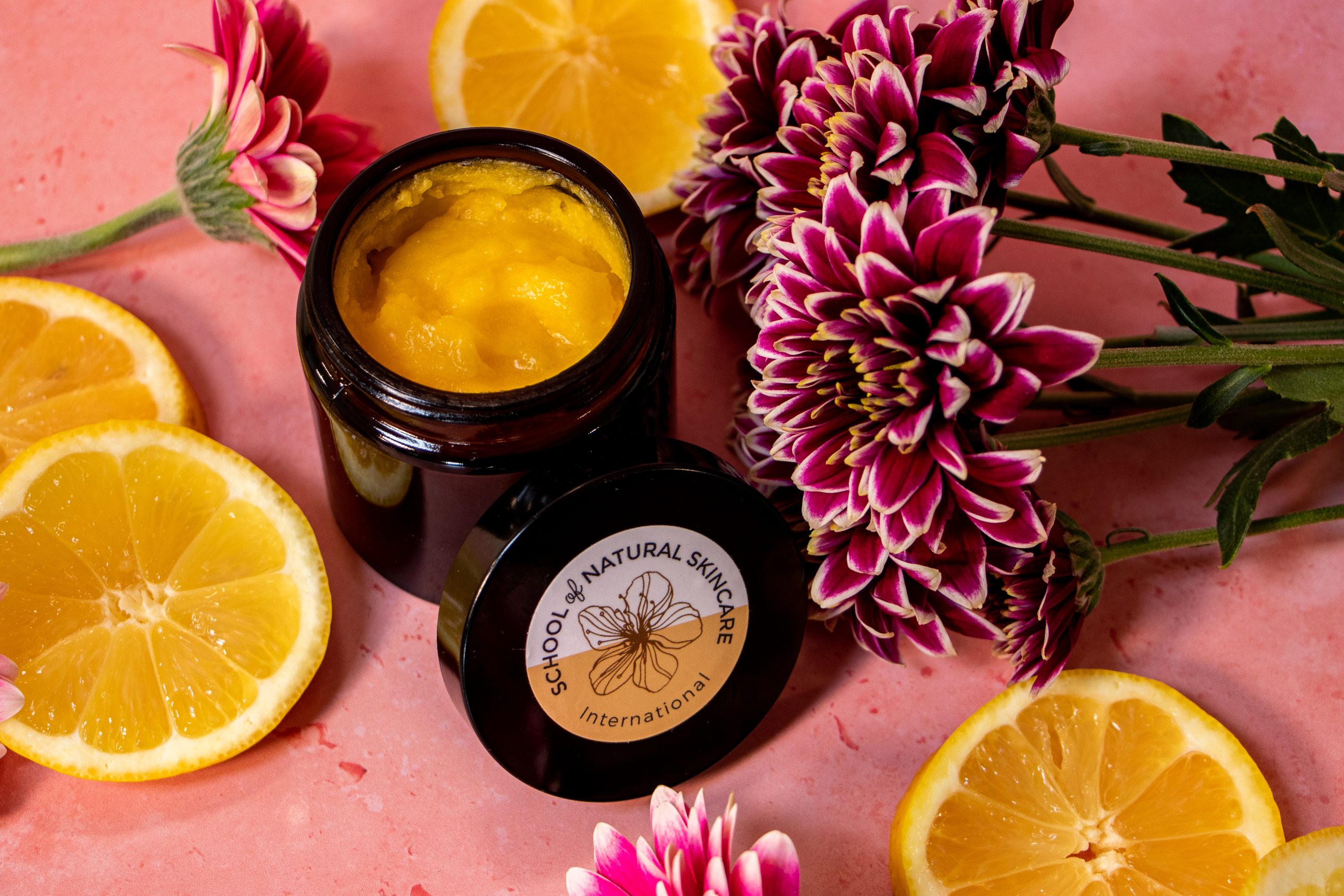 Natural skincare balm with lemons and flowers.