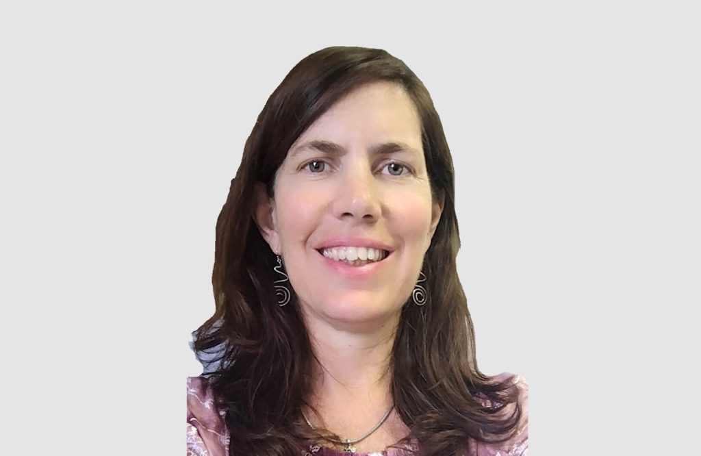 Smiling woman with dark hair and earrings