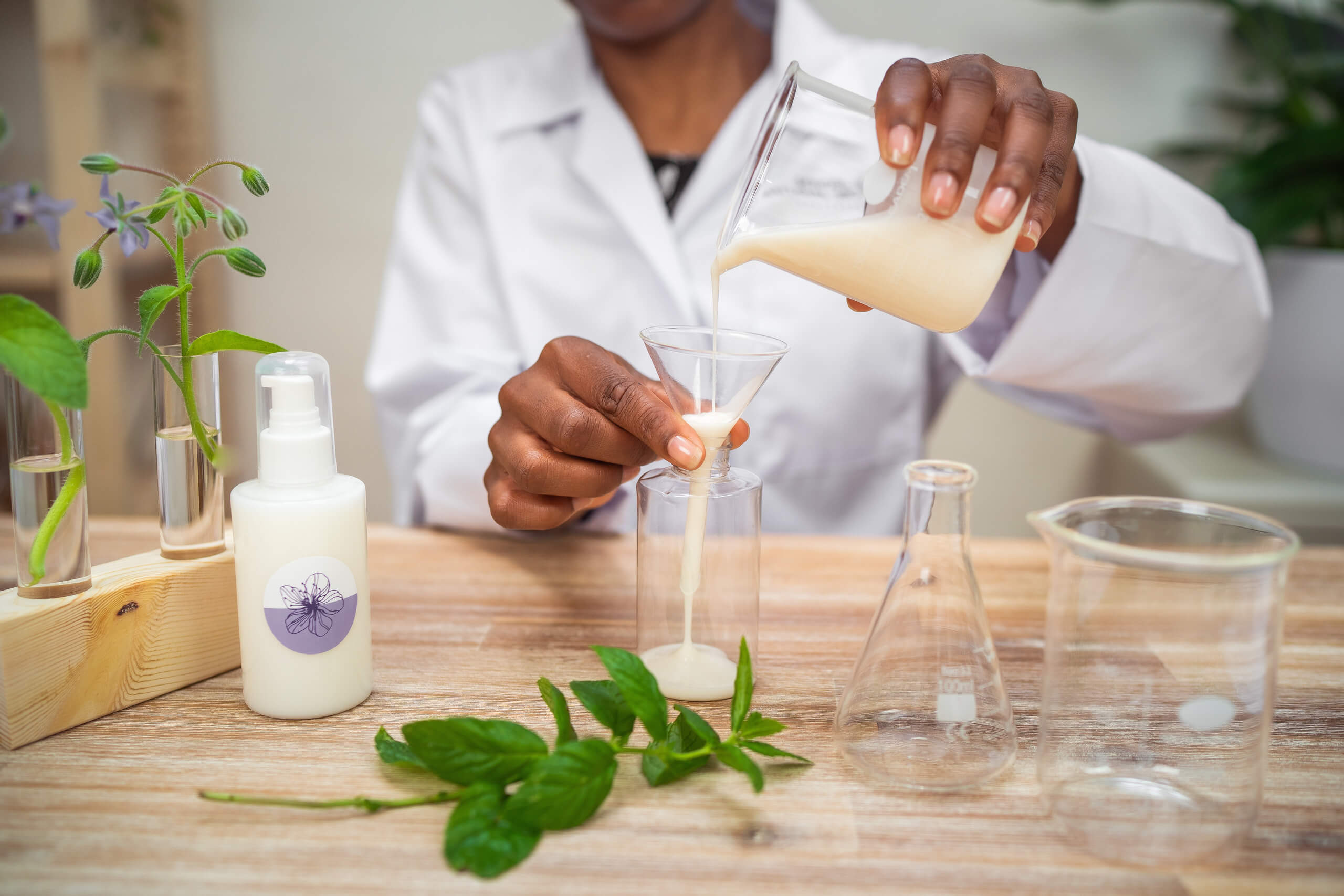 Scientist pouring liquid into a beaker