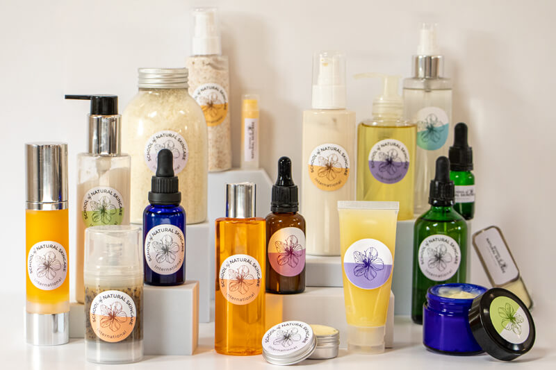 Assorted natural skincare products in various containers.