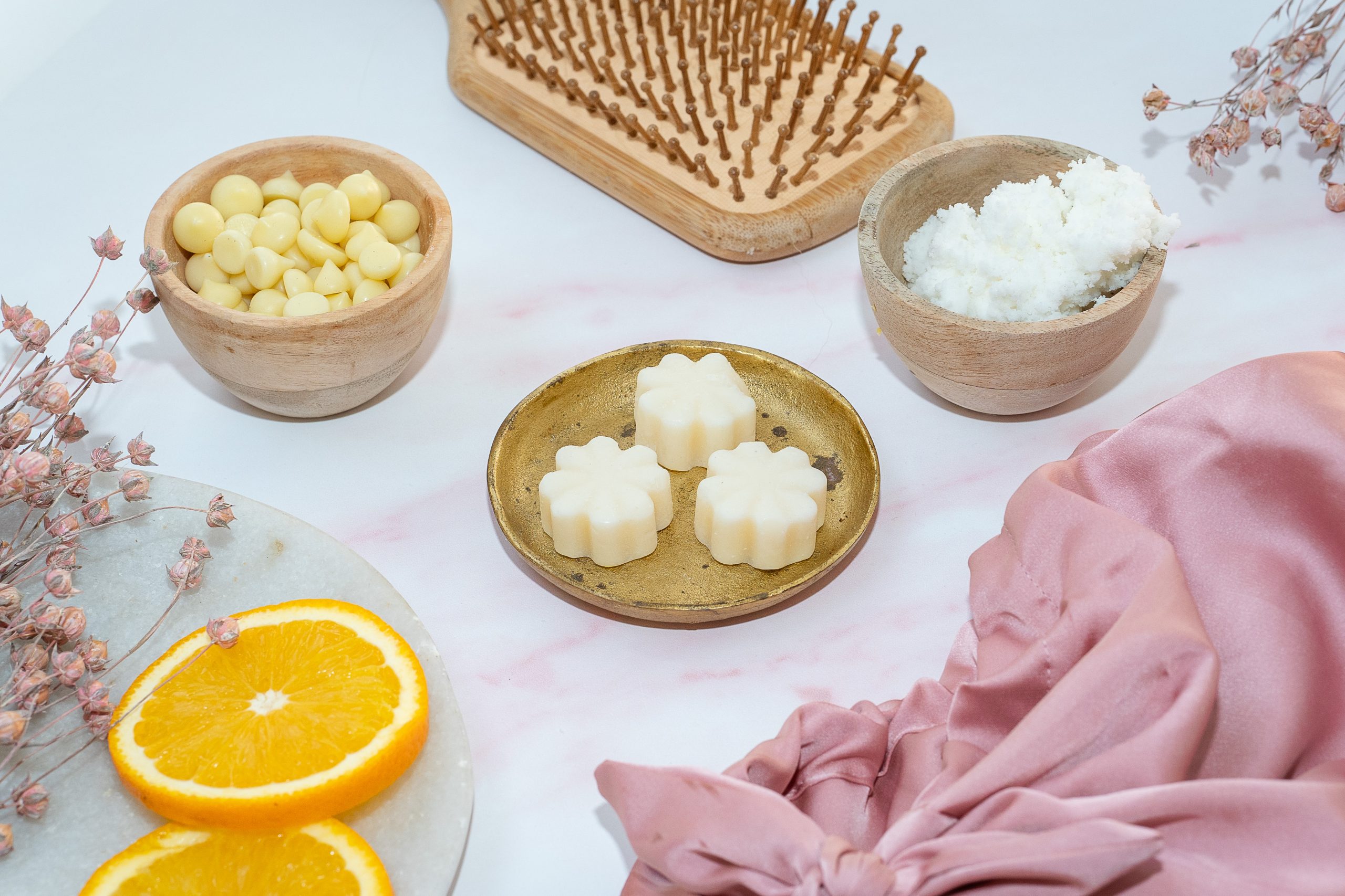 Natural skincare ingredients with brush and silk fabric.