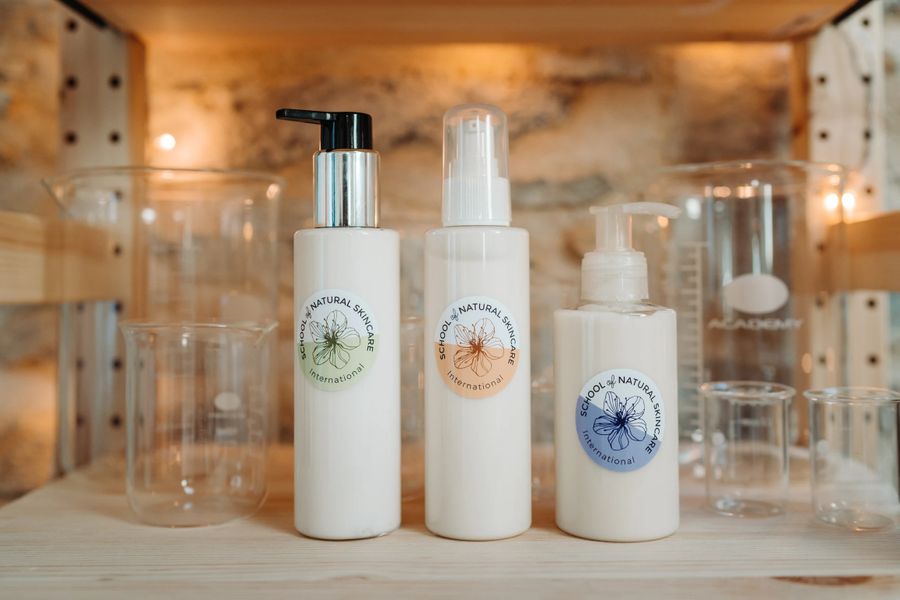 Natural skincare bottles on shelf with glassware