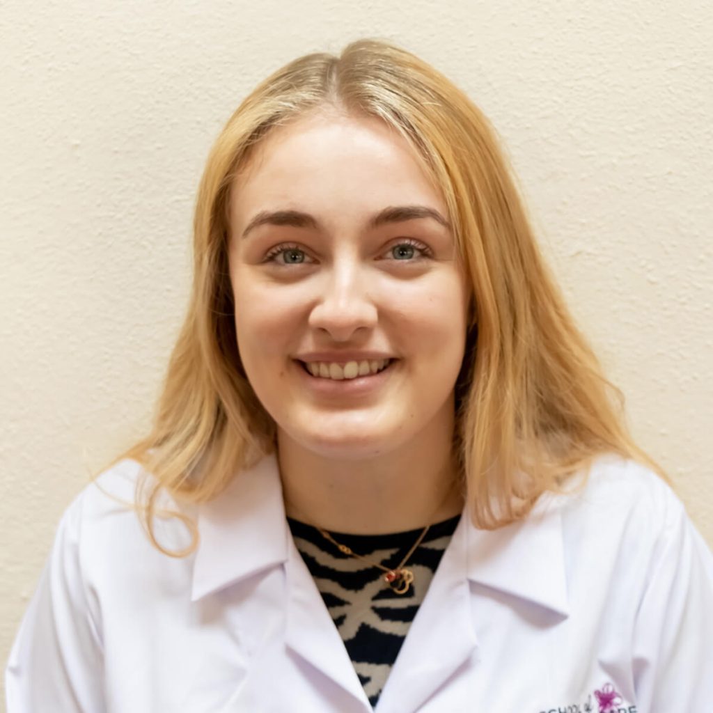 Smiling woman in white lab coat