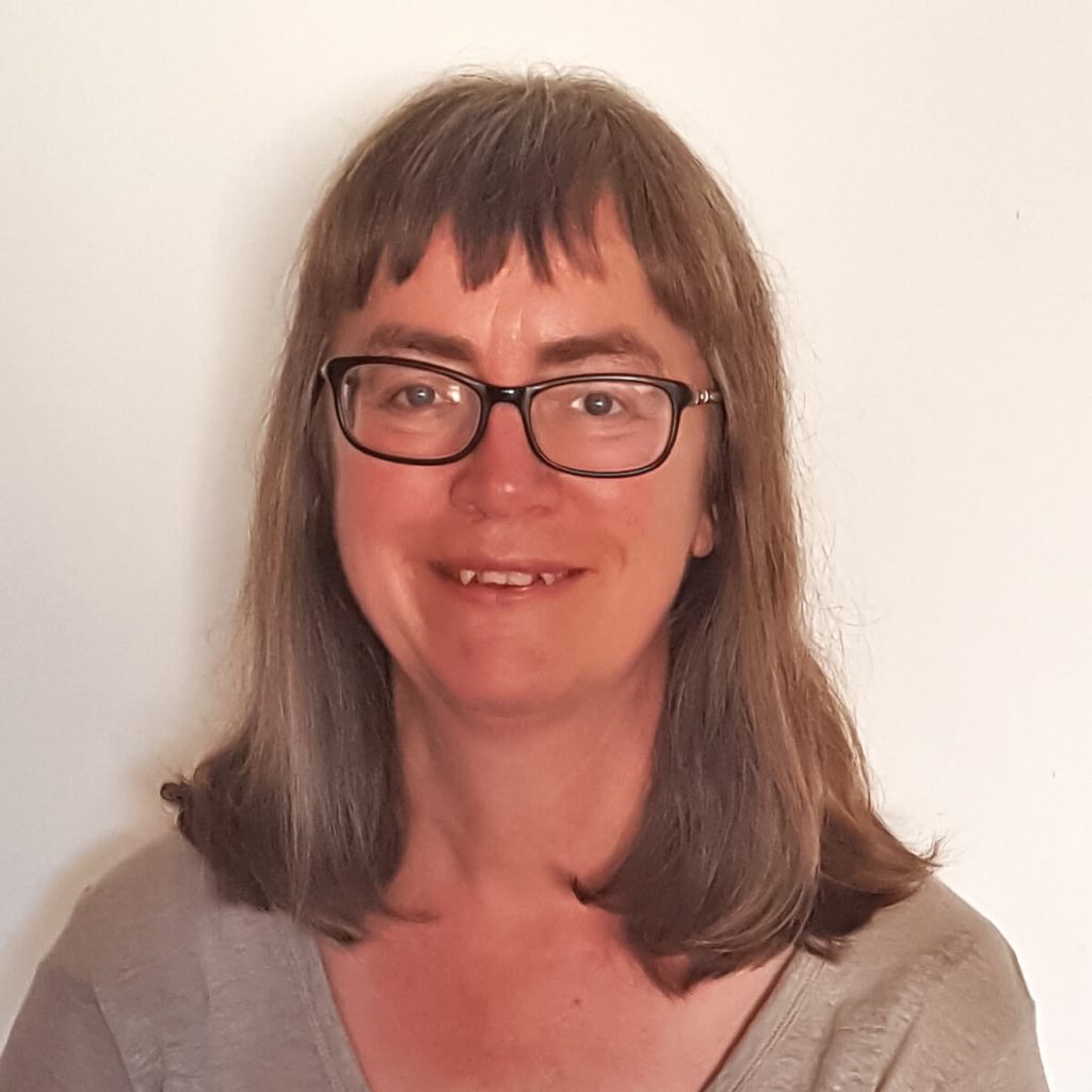 Smiling woman with glasses and long hair