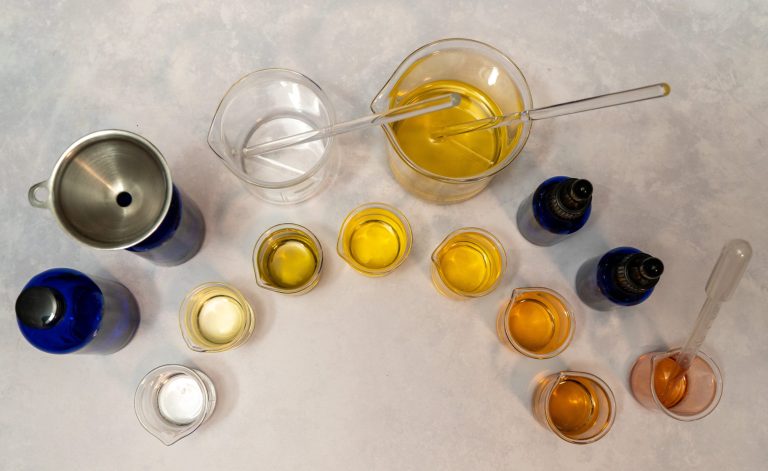 Assorted lab equipment with oils in beakers.