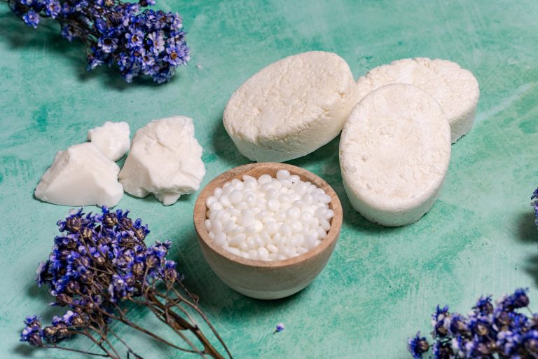 Shea butter and lavender on green background