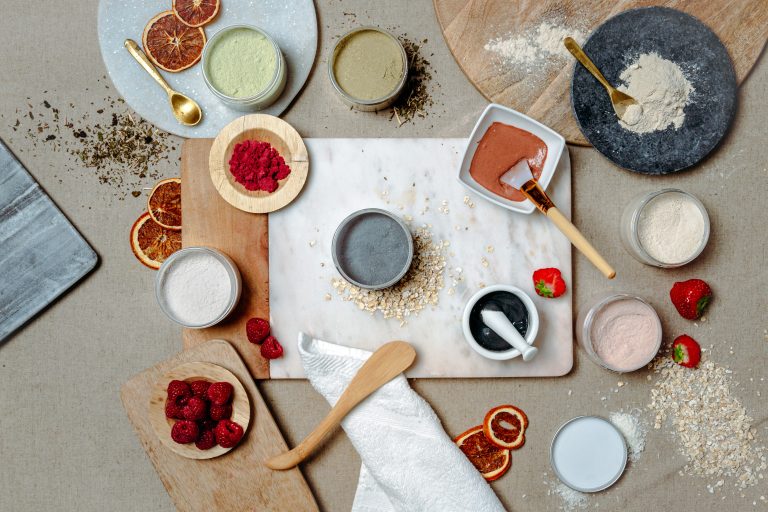 Assorted natural skincare ingredients on wooden boards.