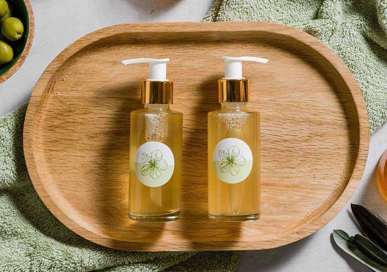 Two olive oil bottles on wooden tray