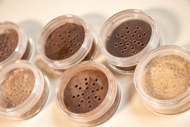 Loose powder makeup in clear containers.