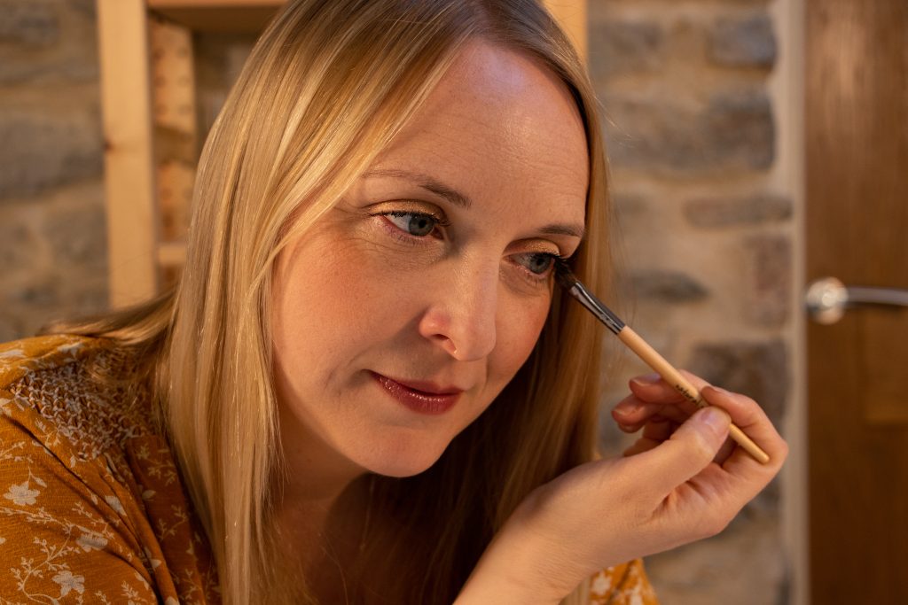 Woman applying makeup with brush