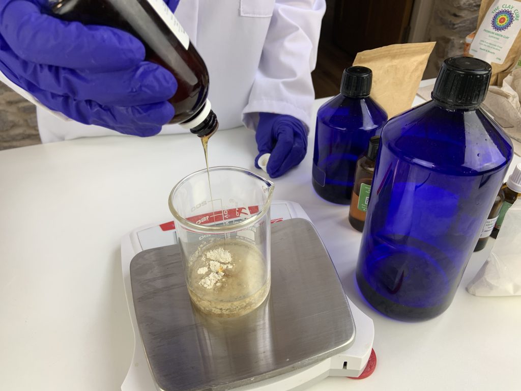 Lab technician pouring liquid into a beaker