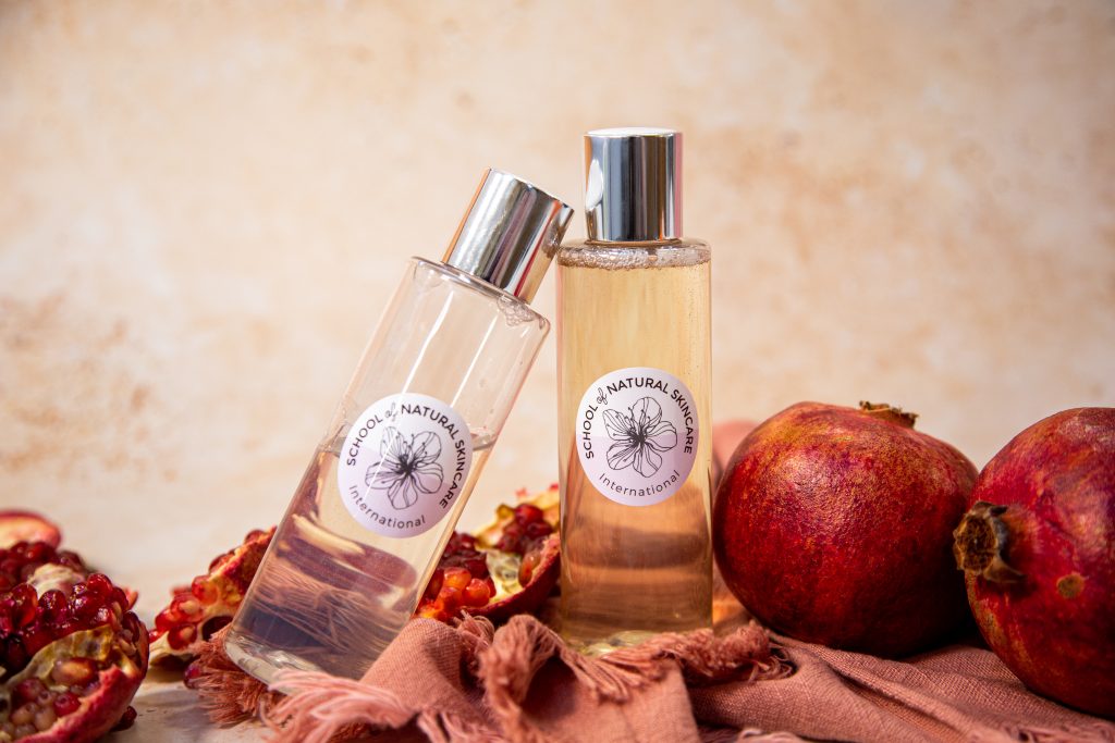 Natural skincare products with pomegranate fruits.