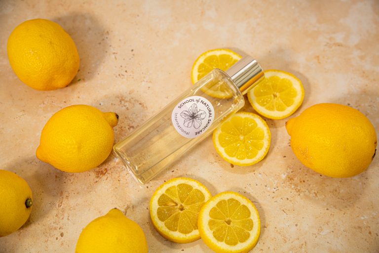 Lemon slices and natural perfume bottle on countertop.