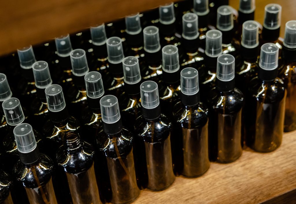 Empty brown spray bottles on wooden surface