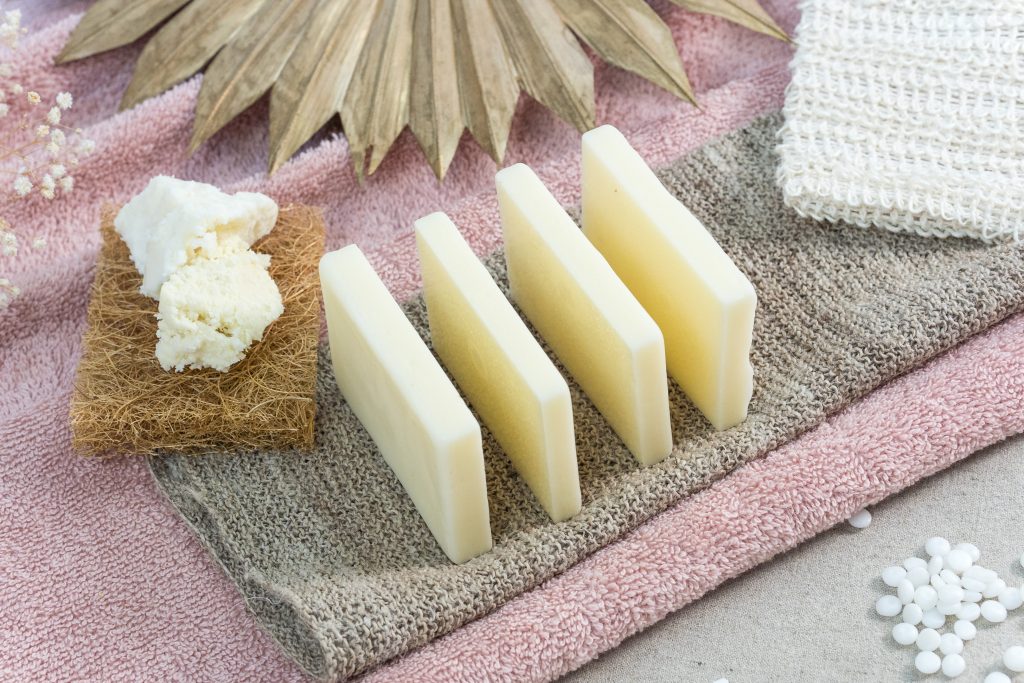 Four natural soap bars on cloths.