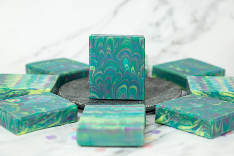 Colorful swirled handmade soaps on gray tray