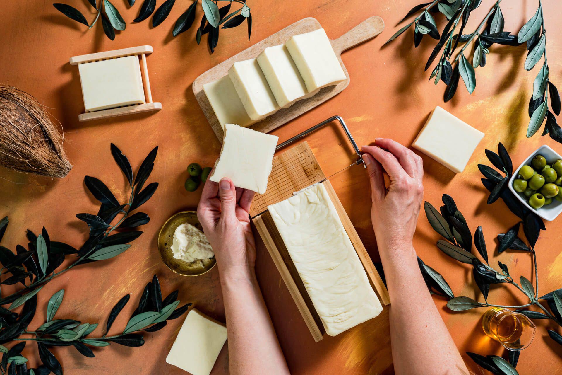 Cutting cheese blocks with a wire slicer.