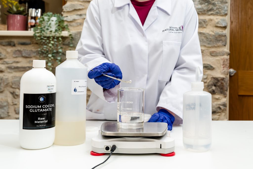 Scientist preparing skincare formula in laboratory.