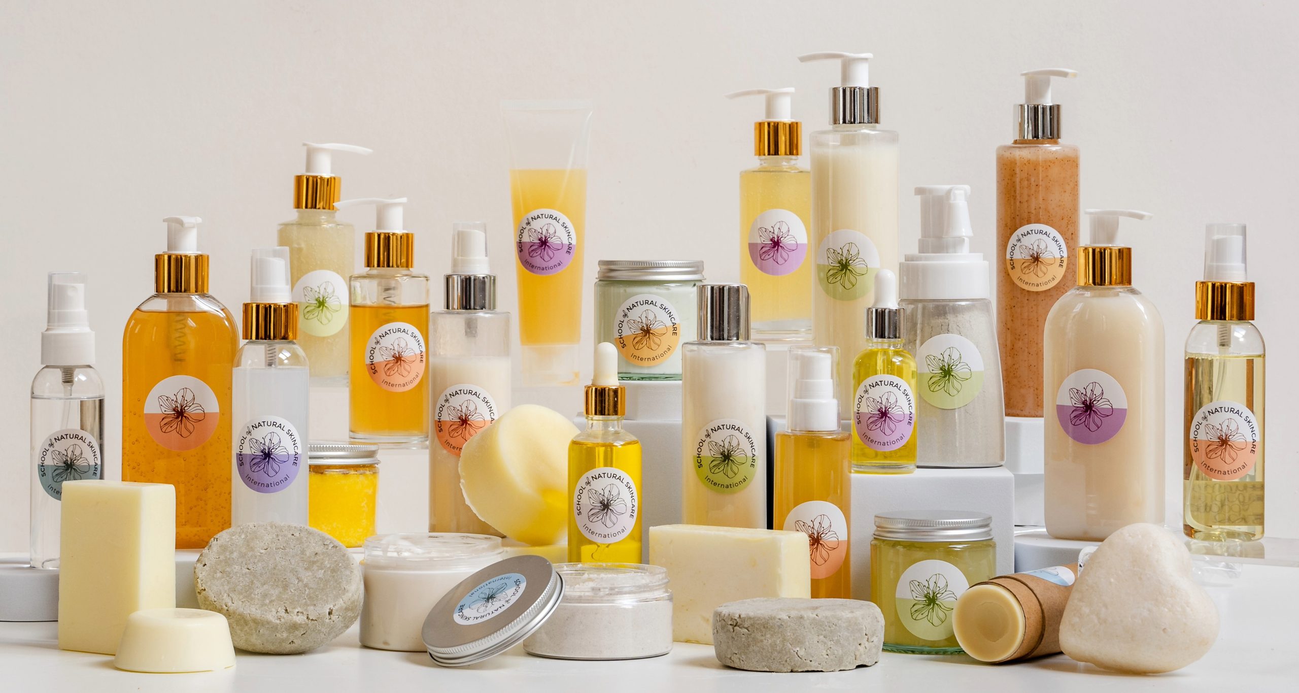 Assorted natural skincare products in bottles and jars.