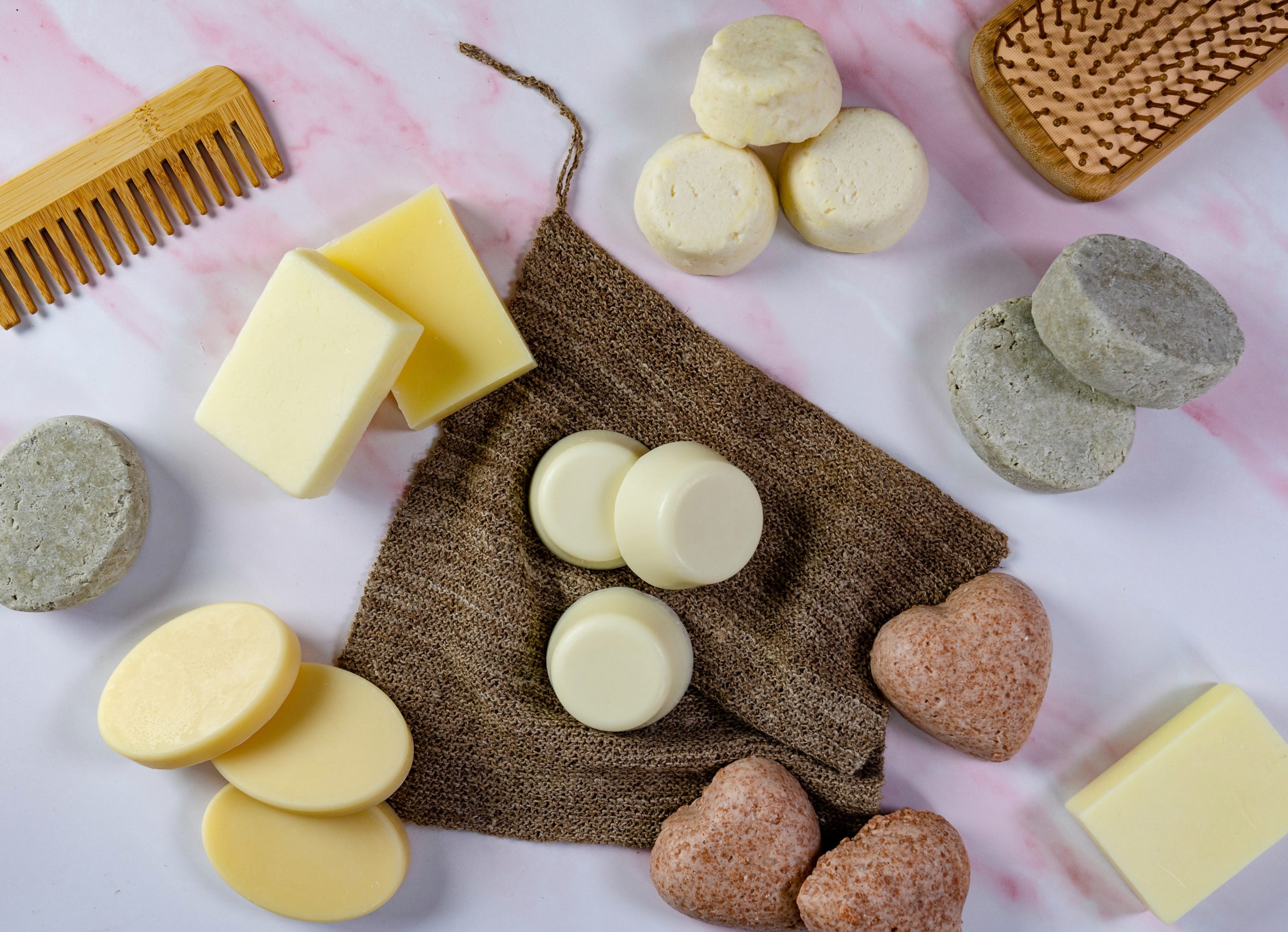 Assorted solid shampoo bars with comb on display.