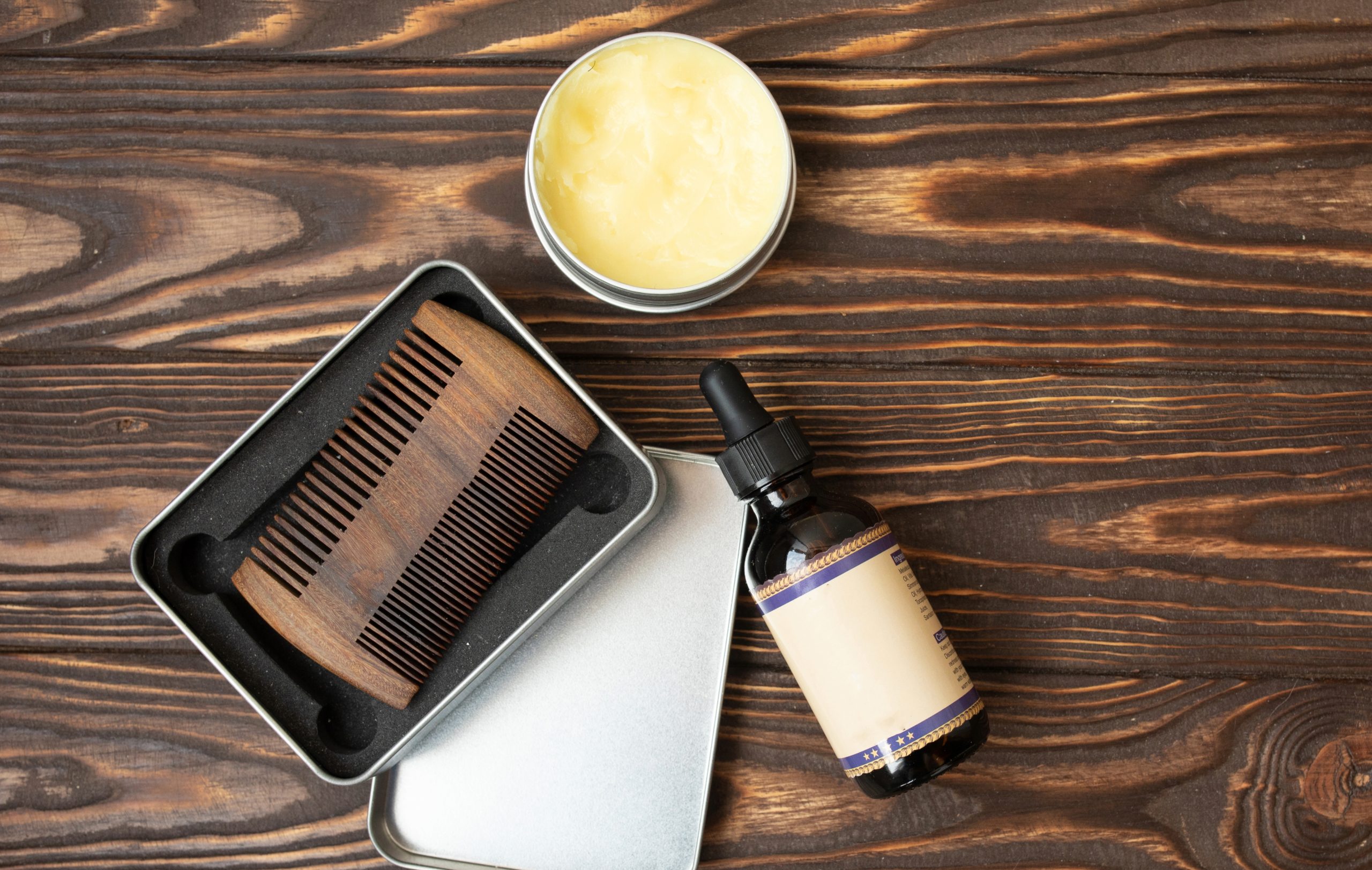 Beard grooming kit with oil and comb.