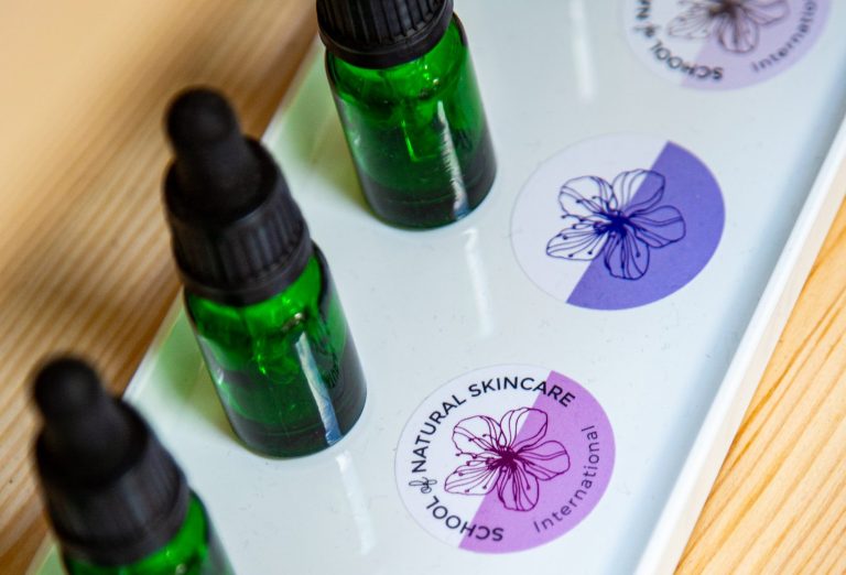 Green droppers with School of Natural Skincare stickers