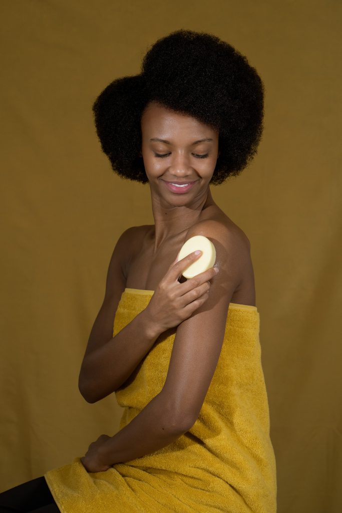 Person using body brush on shoulder