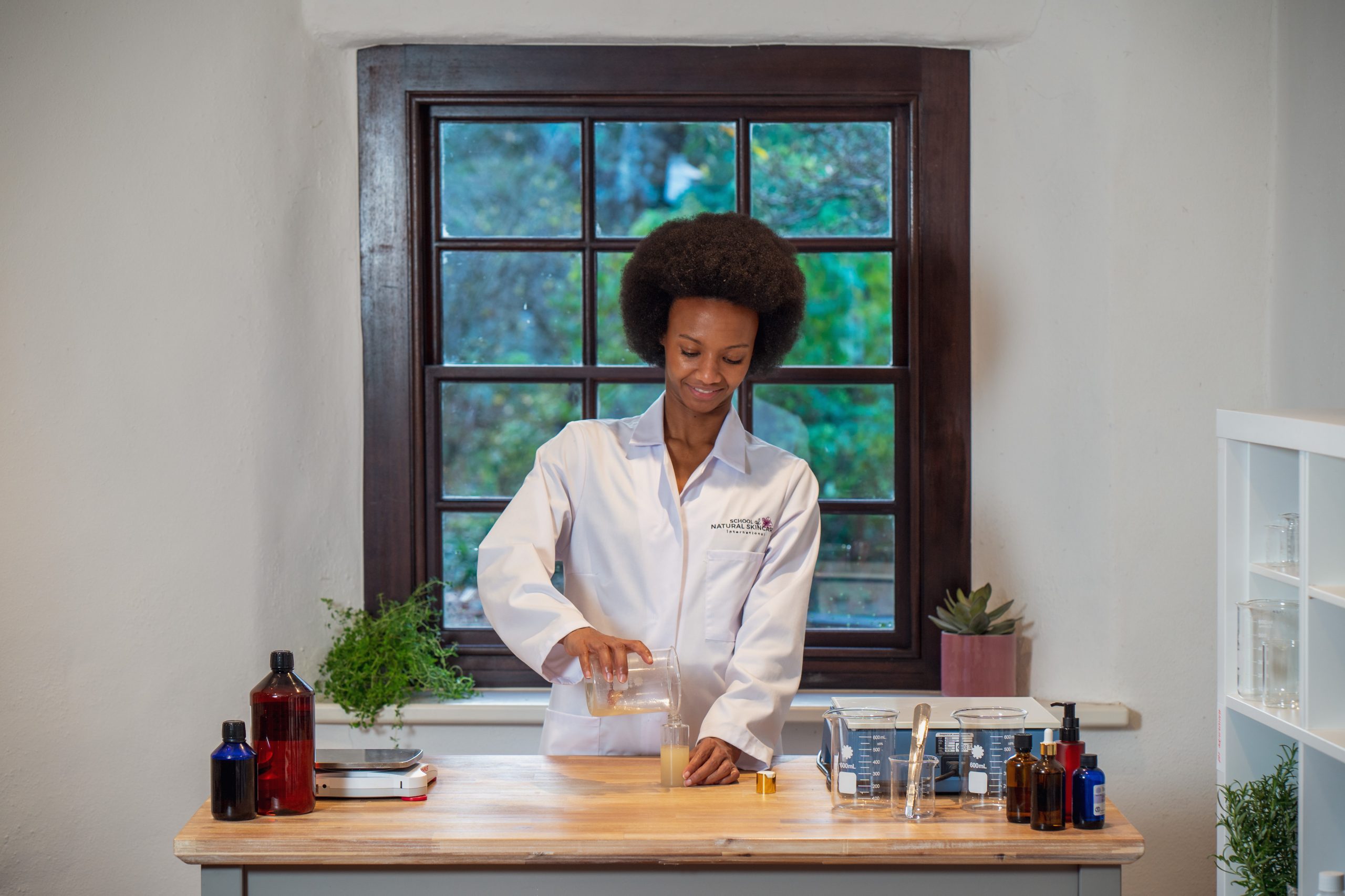 Scientist mixing ingredients in a lab setting.