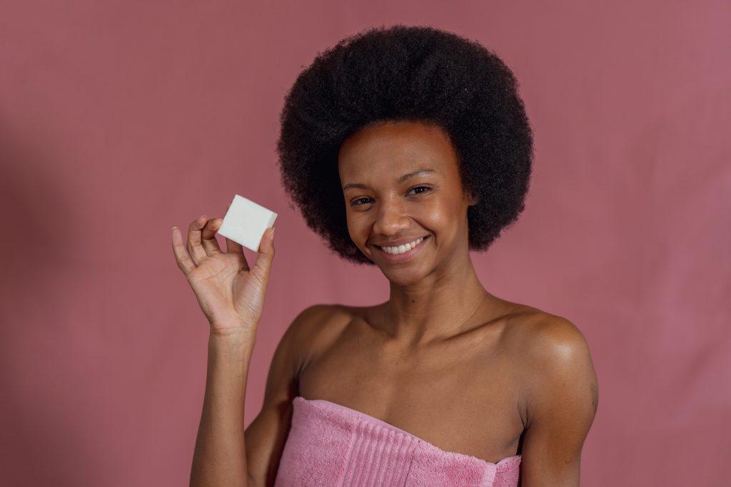 Smiling woman holding a bar of soap