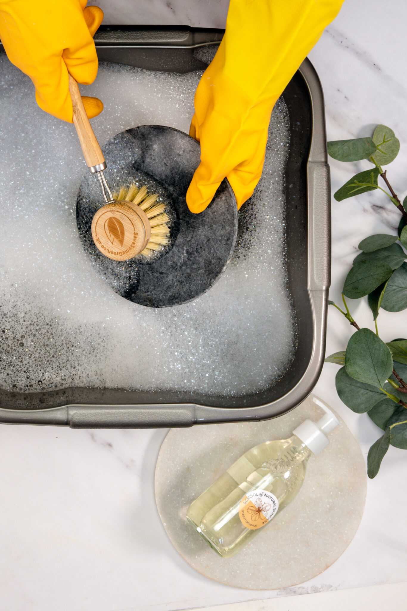 Washing a pan with soap and brush