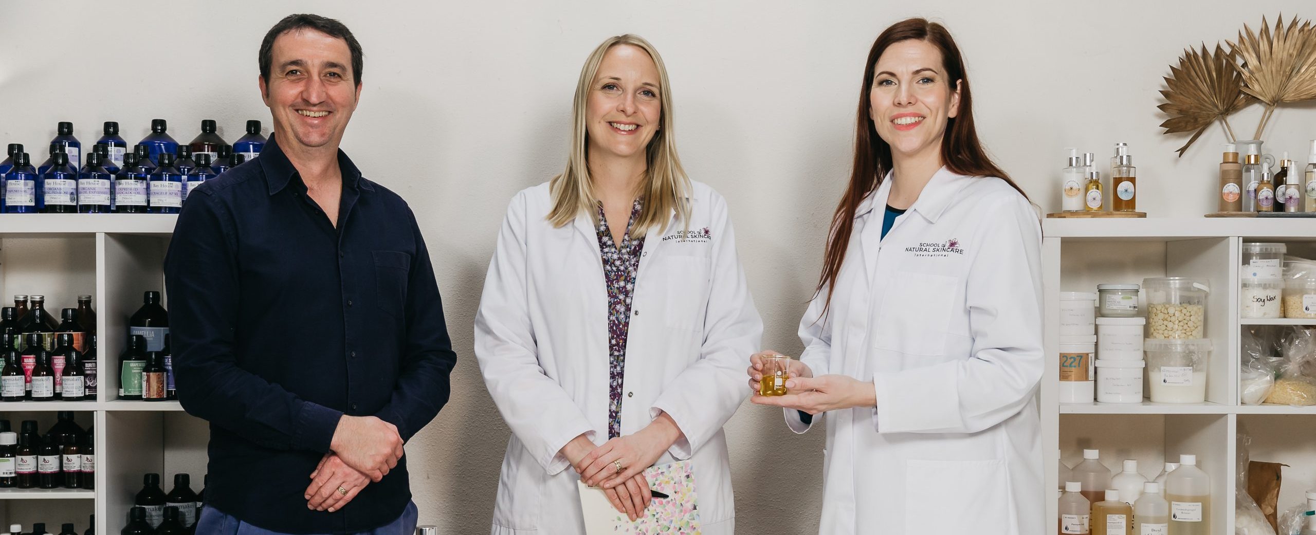 Three skincare experts in a product lab.