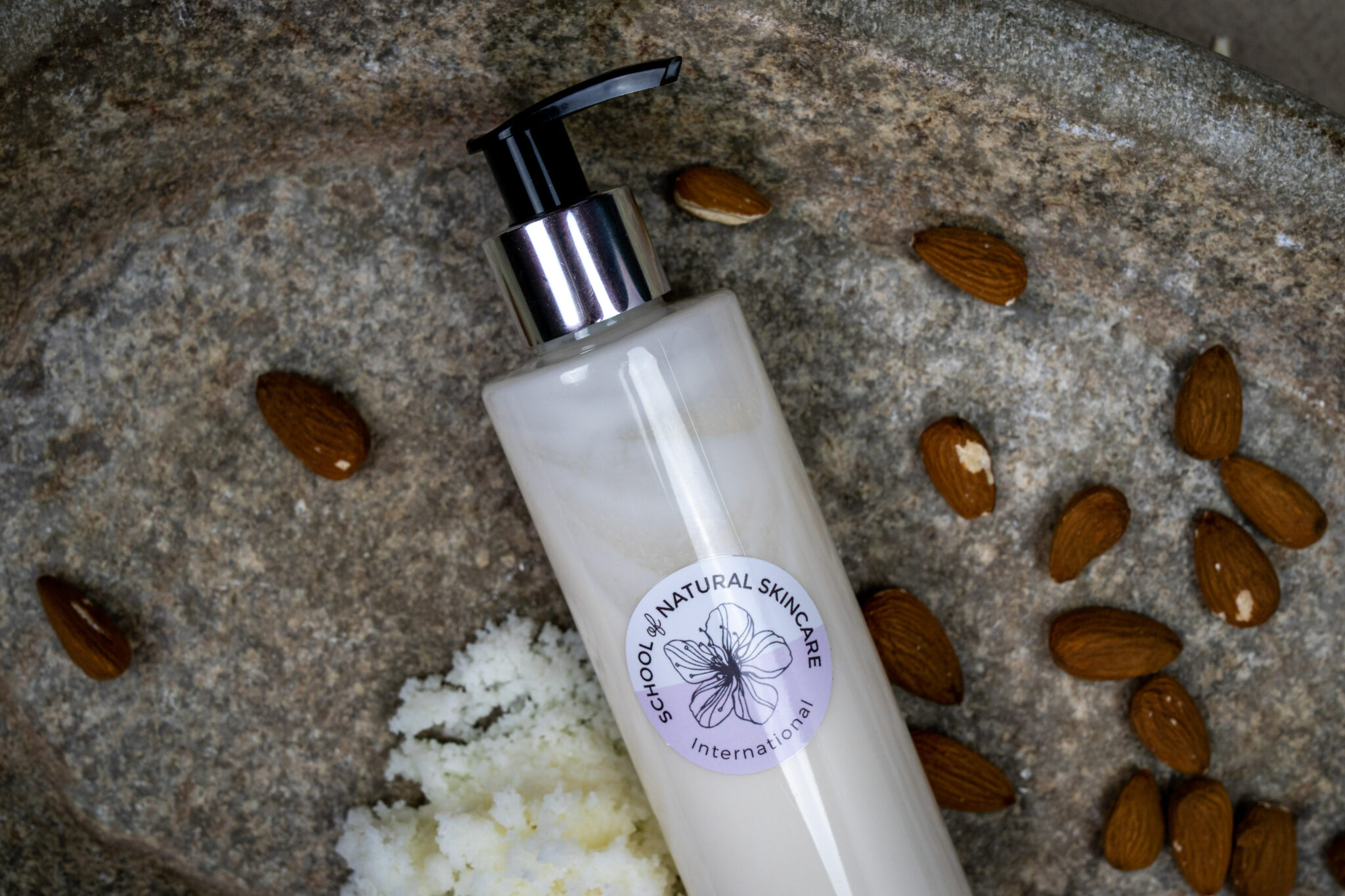 Natural skincare bottle with almonds and shea butter