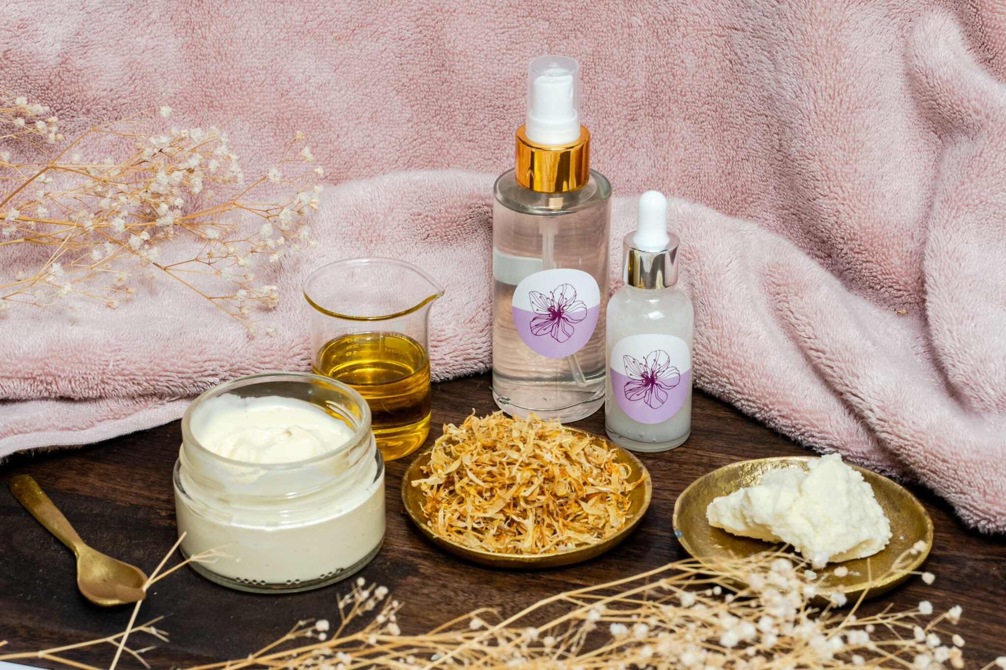 Natural skincare products with flowers and oils.