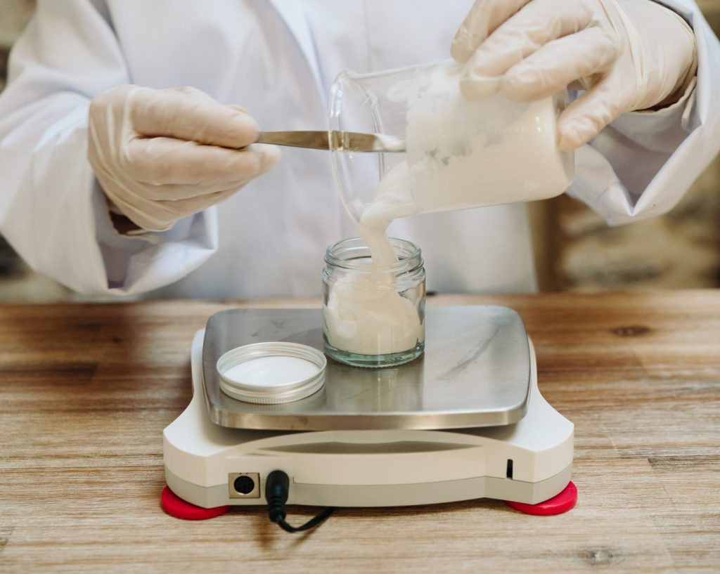 Measuring cream in a jar on digital scale