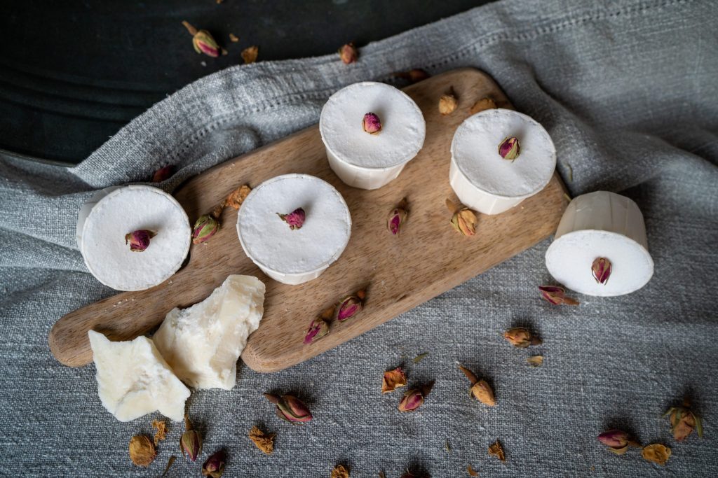 Round white soaps with rosebuds on board