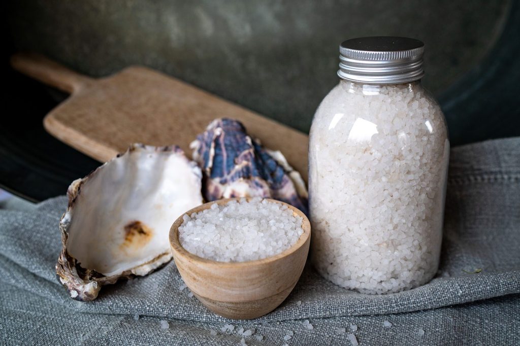 Sea salt in jar and bowl with shells