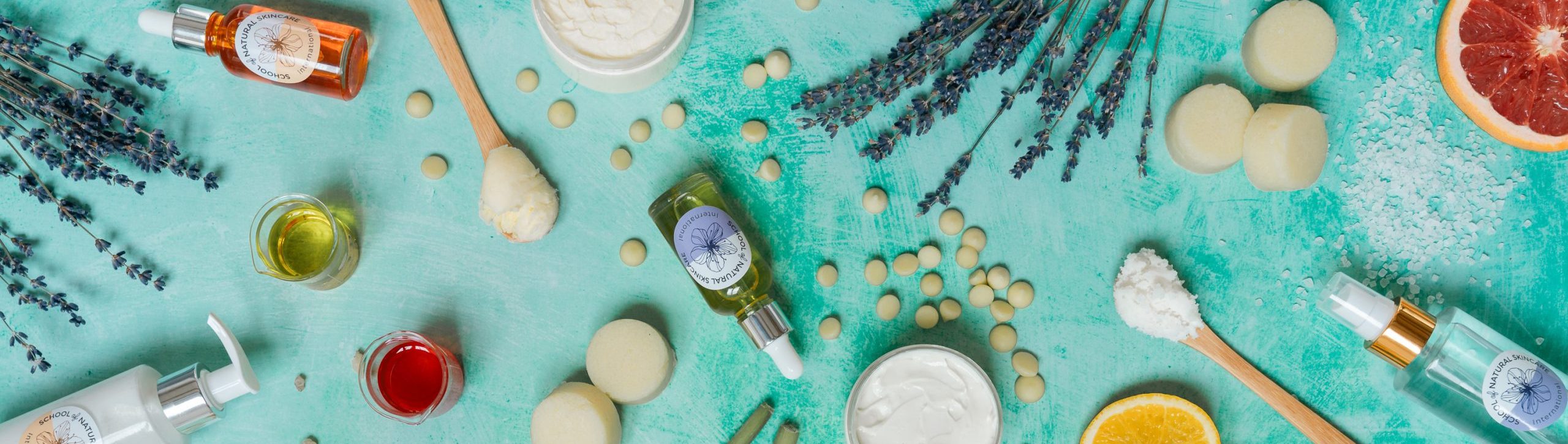 Natural skincare products and ingredients on teal background.