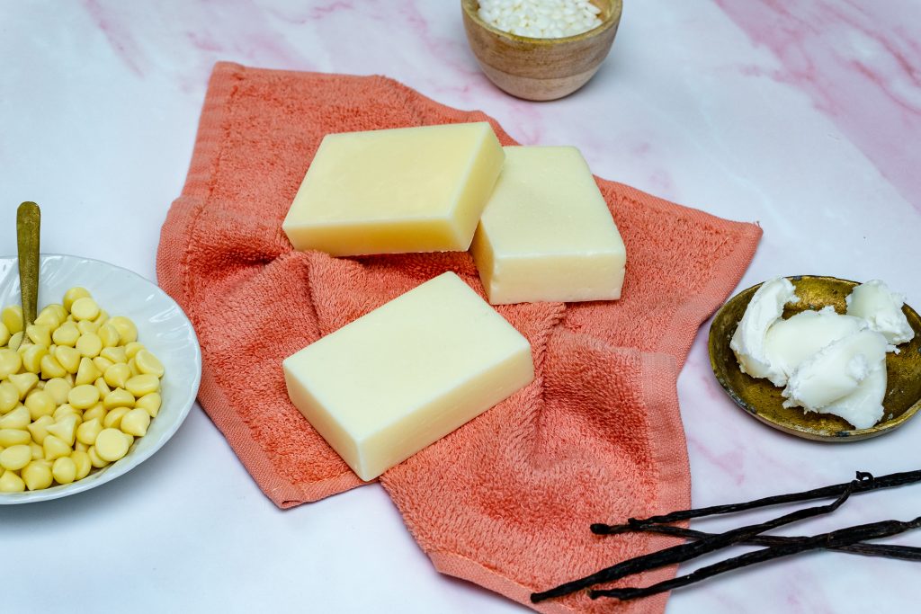 Natural soap bars with ingredients on towel