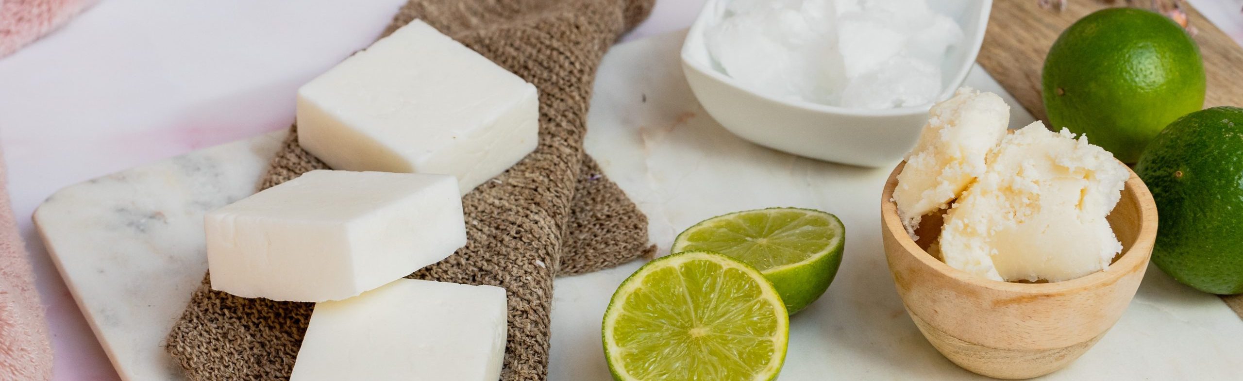 Coconut oil, shea butter, and lime on table