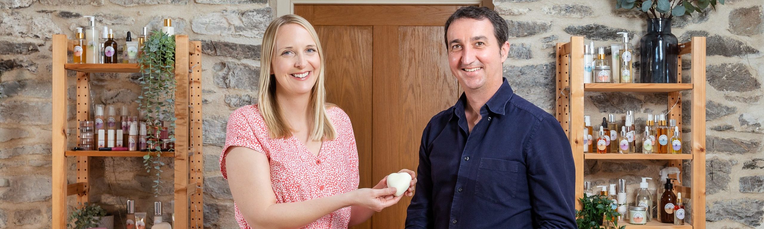 Two people with handcrafted skincare products.