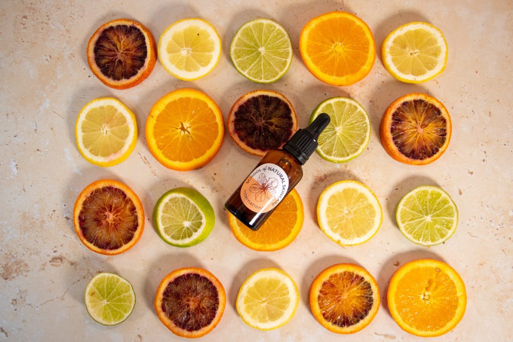 Citrus slices with essential oil bottle