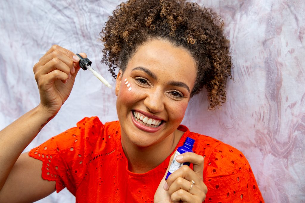 Woman applying facial serum with dropper