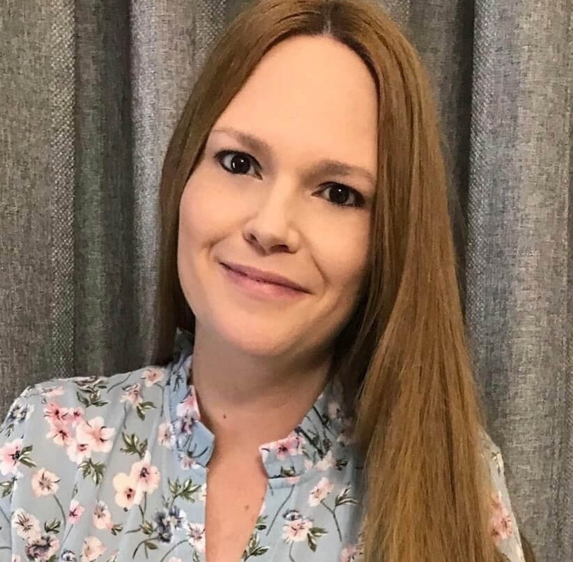 Smiling woman in floral shirt indoors