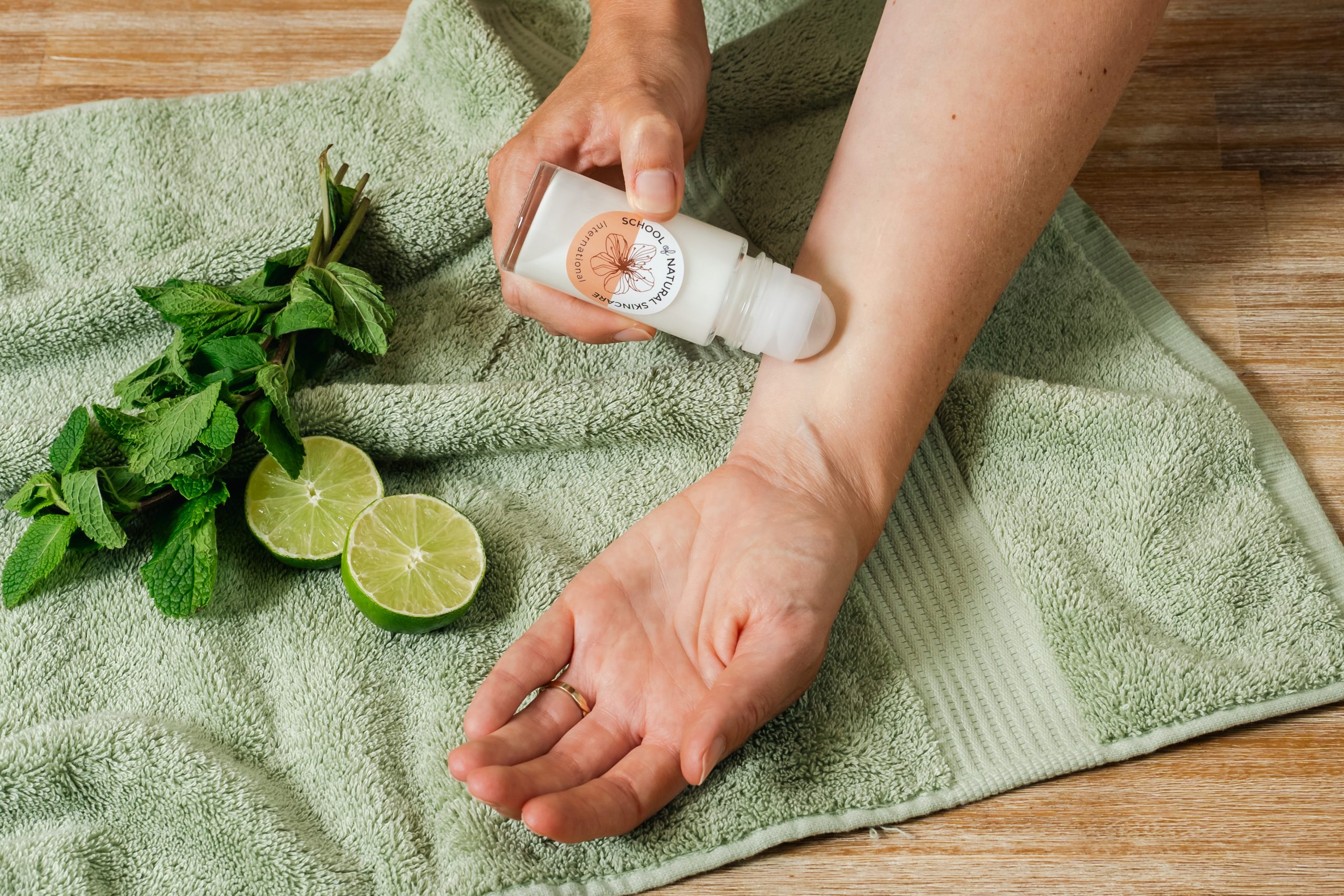 Applying natural deodorant on arm with lime and mint.