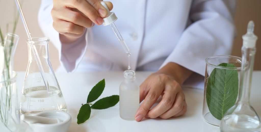 Person using dropper with chemicals and leaves