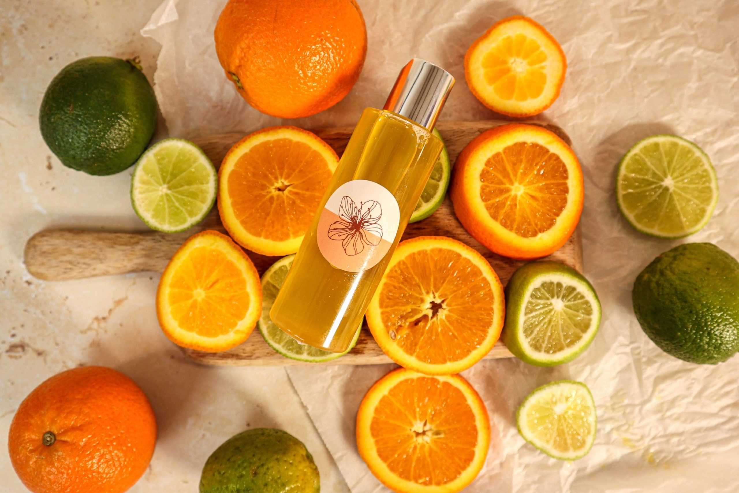 Citrus fruits with citrus-scented oil bottle