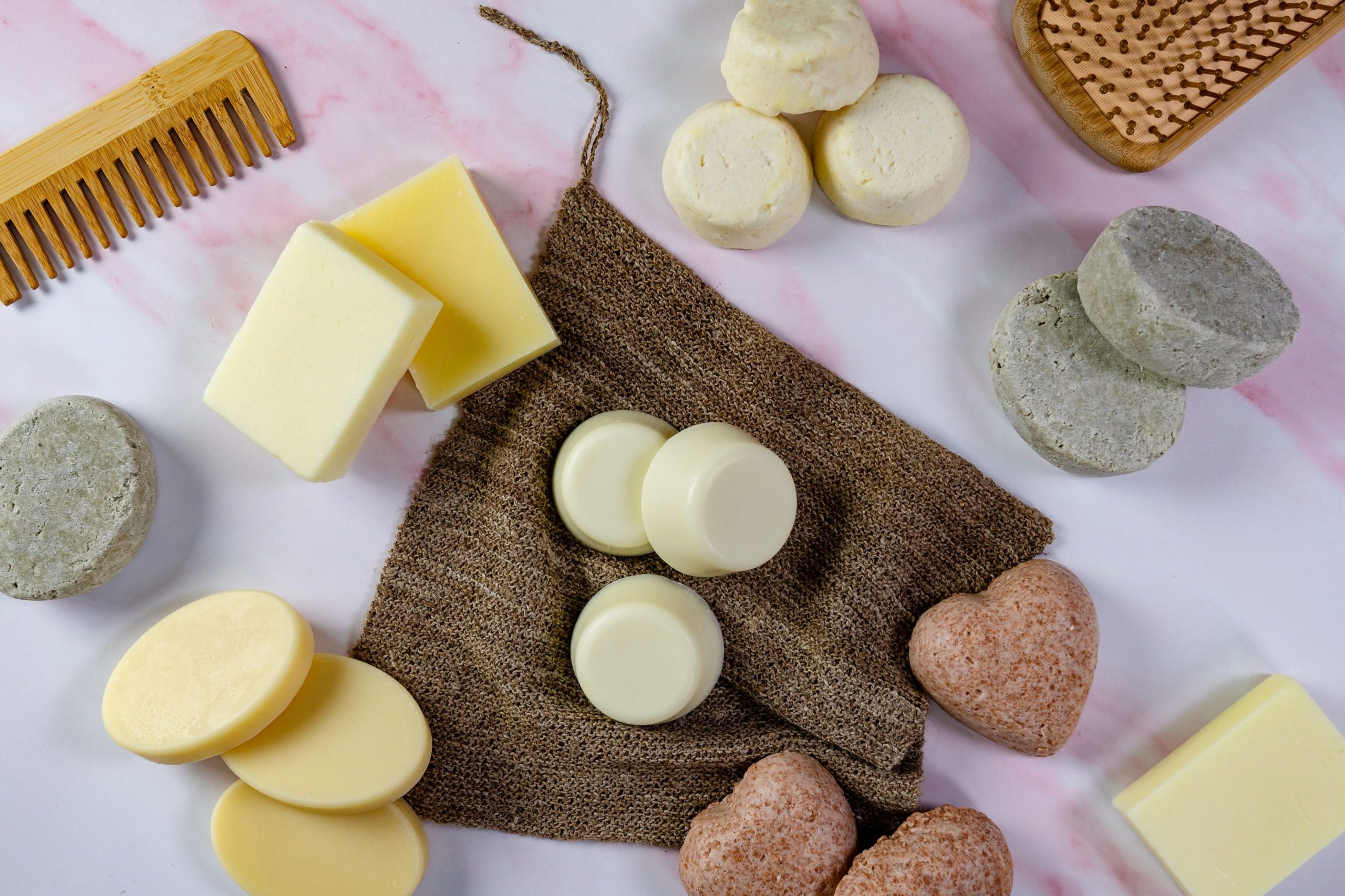 Assorted solid shampoo bars with comb on display.