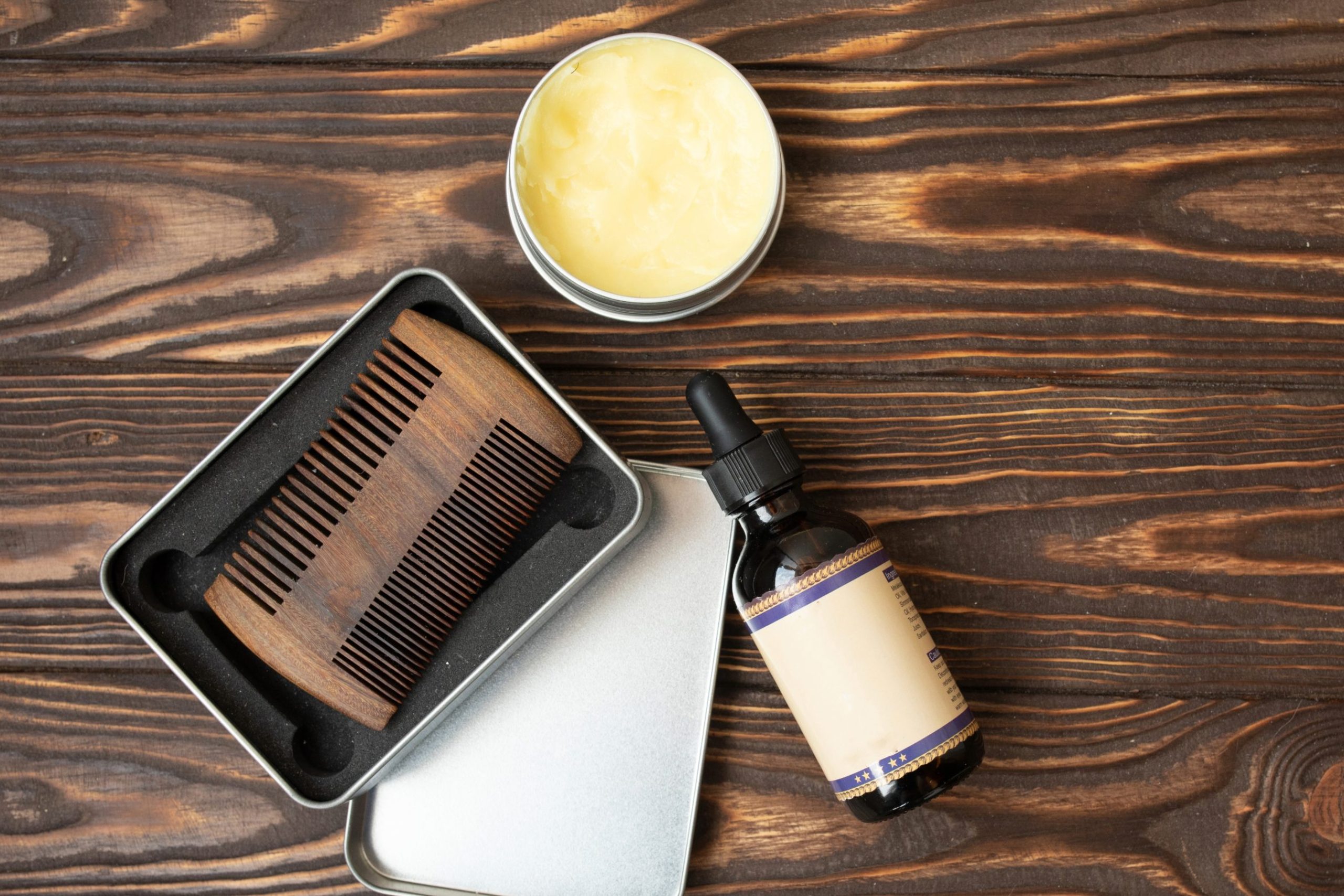 Beard grooming kit with oil and comb.